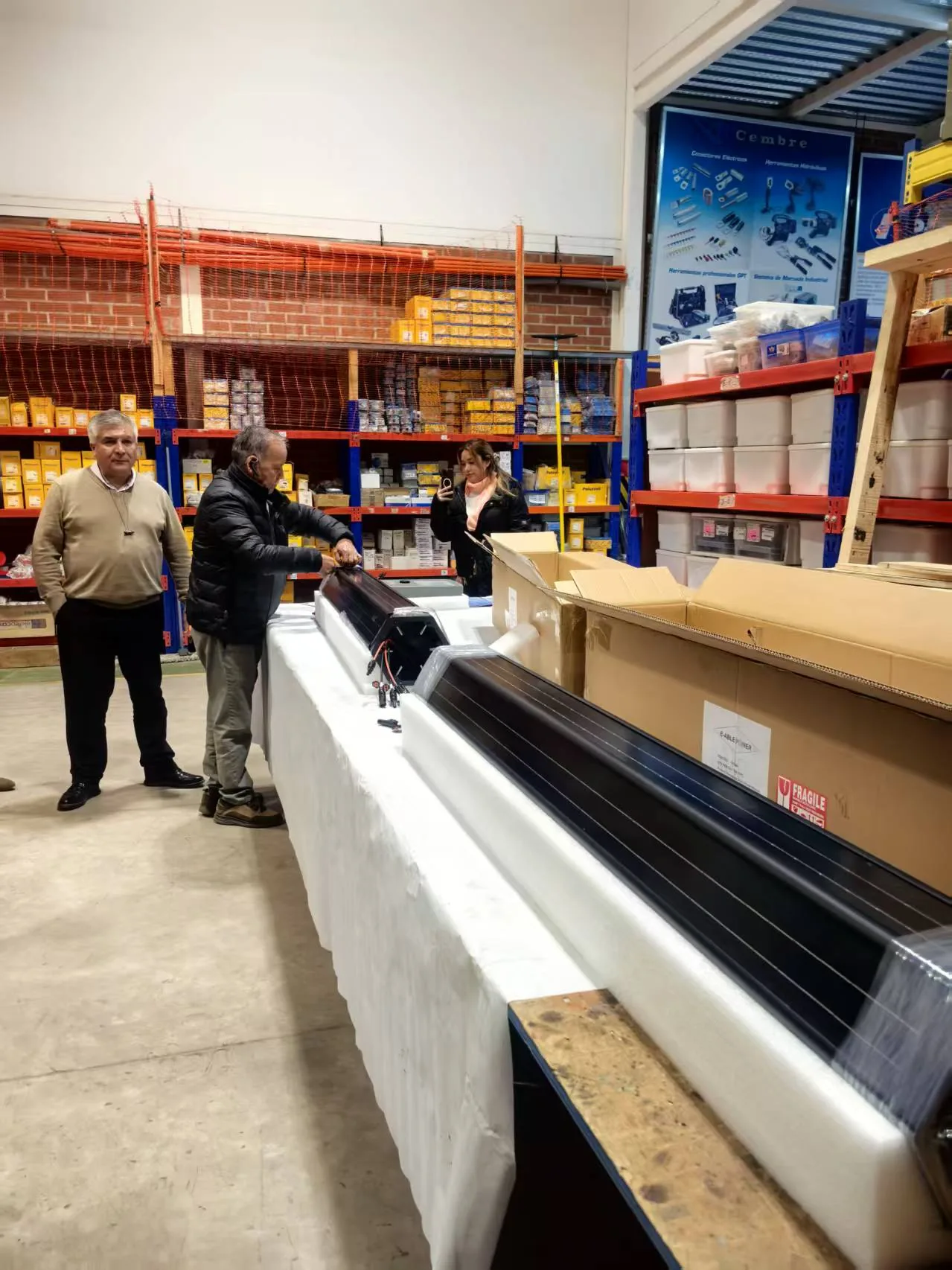 Close inspection of a SolarWrap vertical solar module on the warehouse bench before installation