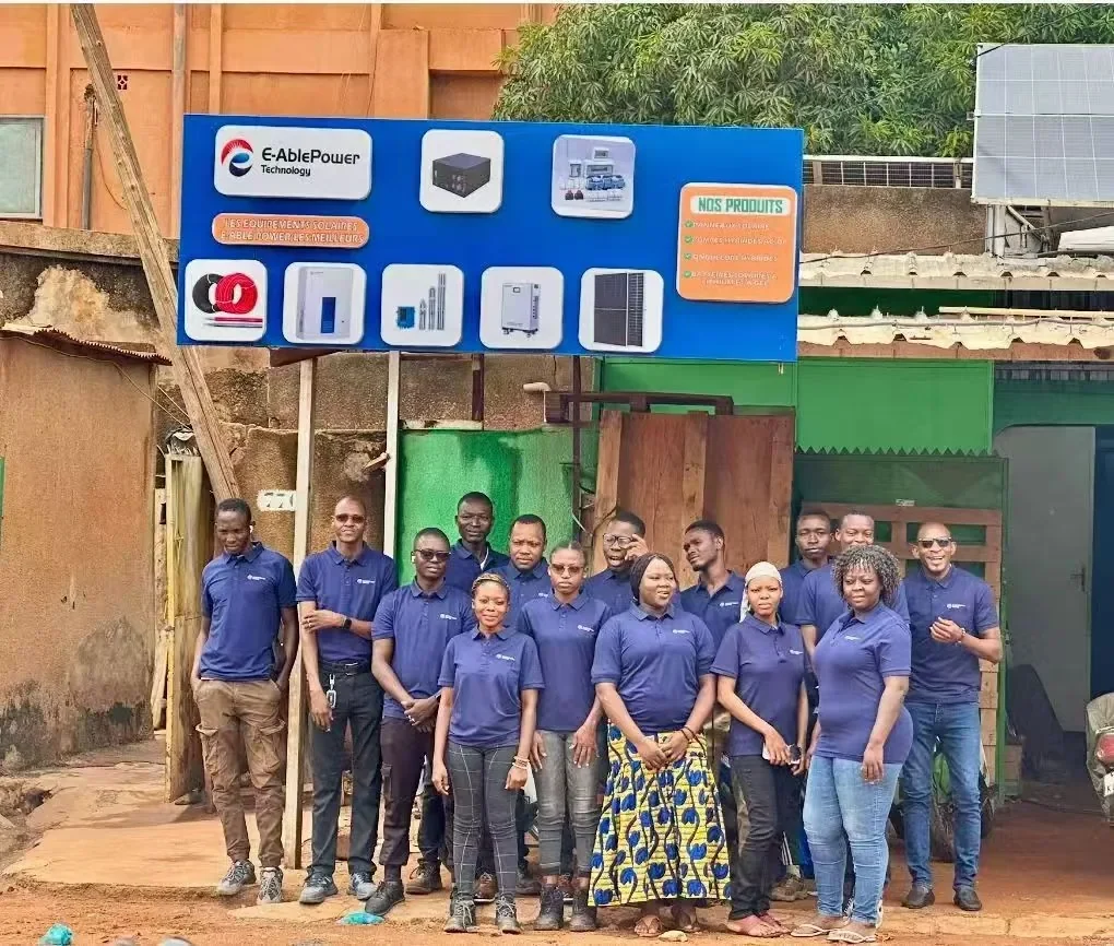 E-Able Power overseas partner team in front of a partner storefront