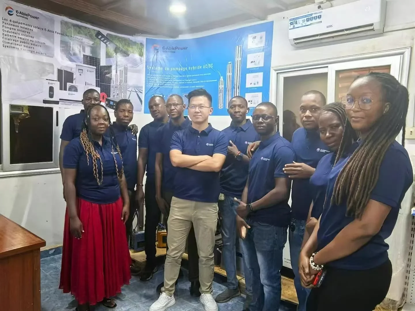E-Able Power distributor team in the solar showroom with E-AblePower product posters